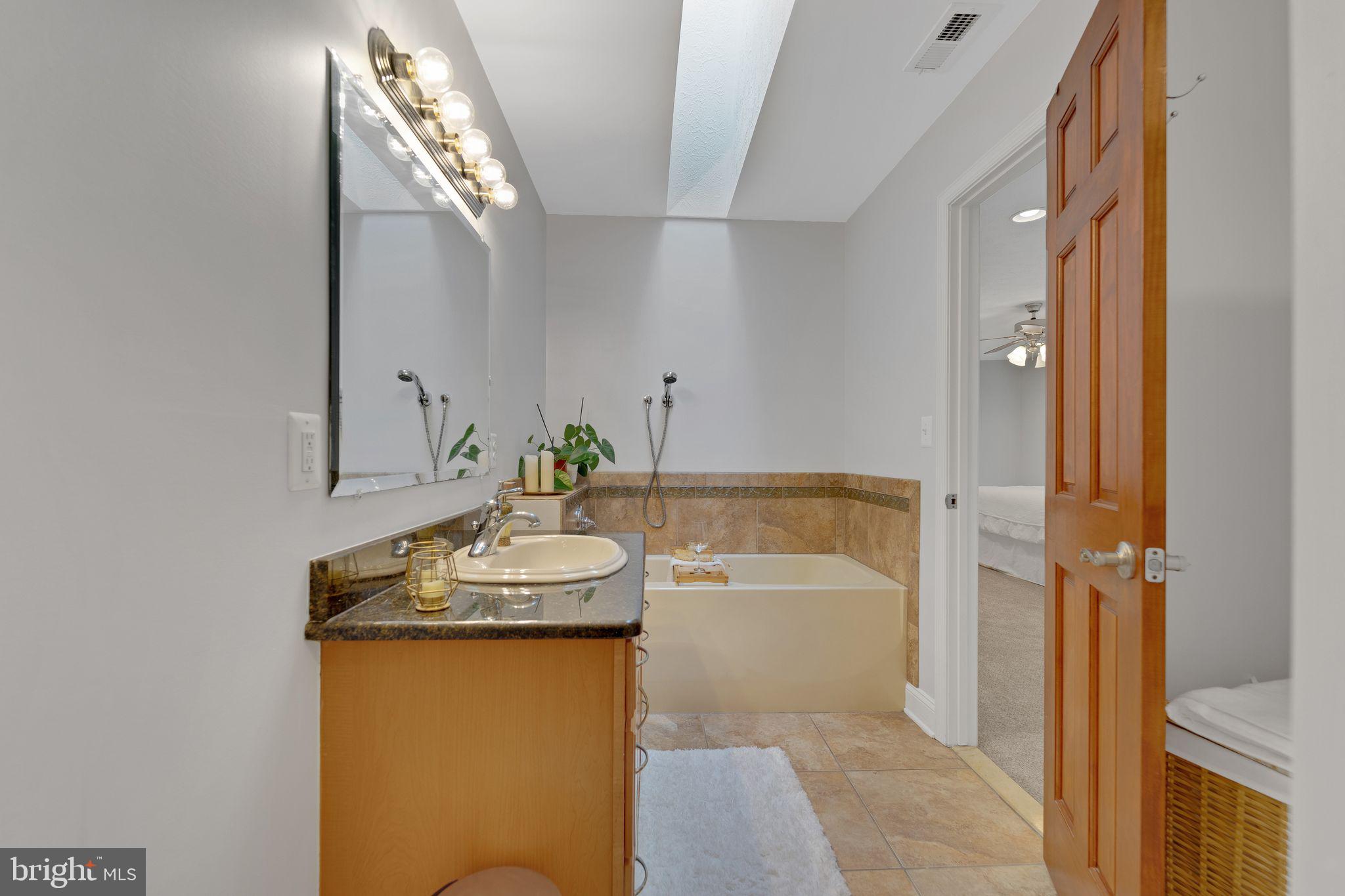 1012 B And L Club Road Pasadena, MD 21122 - Photo 29 of 54 Primary en-suite w/skylight and jetted tub