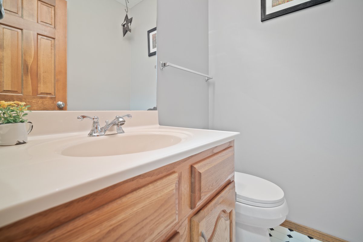 2606 Persimmon Place Bloomington, IL 61701 - Photo 13 of 19 a bathroom with a sink a toilet and a mirror