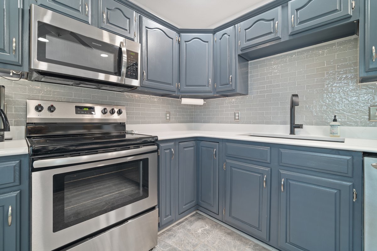 2606 Persimmon Place Bloomington, IL 61701 - Photo 7 of 19 a kitchen with stainless steel appliances granite countertop white cabinets a sink and dishwasher