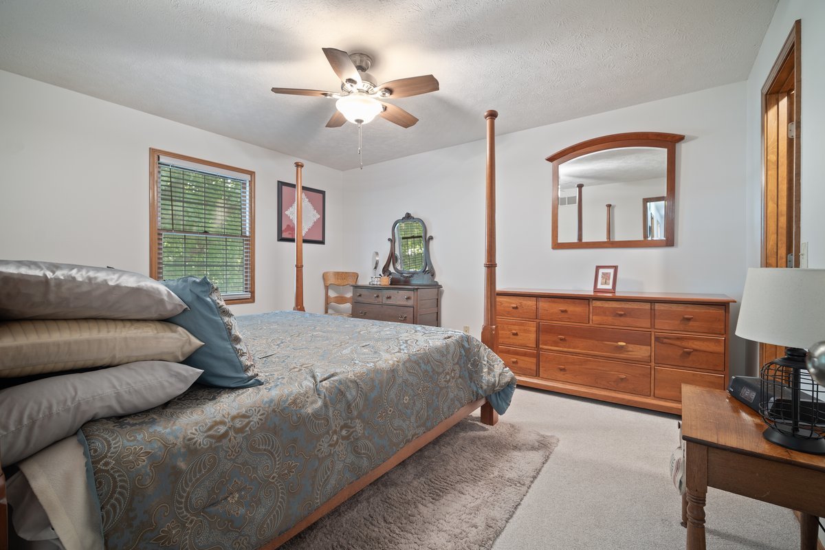 2606 Persimmon Place Bloomington, IL 61701 - Photo 10 of 19 a bedroom with a large bed and a chandelier