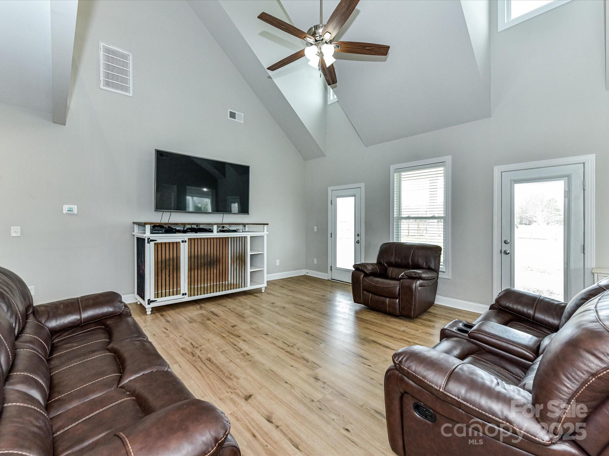899 Hasty Road Marshville, NC 28103 - Photo 12 of 44 a living room with furniture a flat screen tv and a fireplace