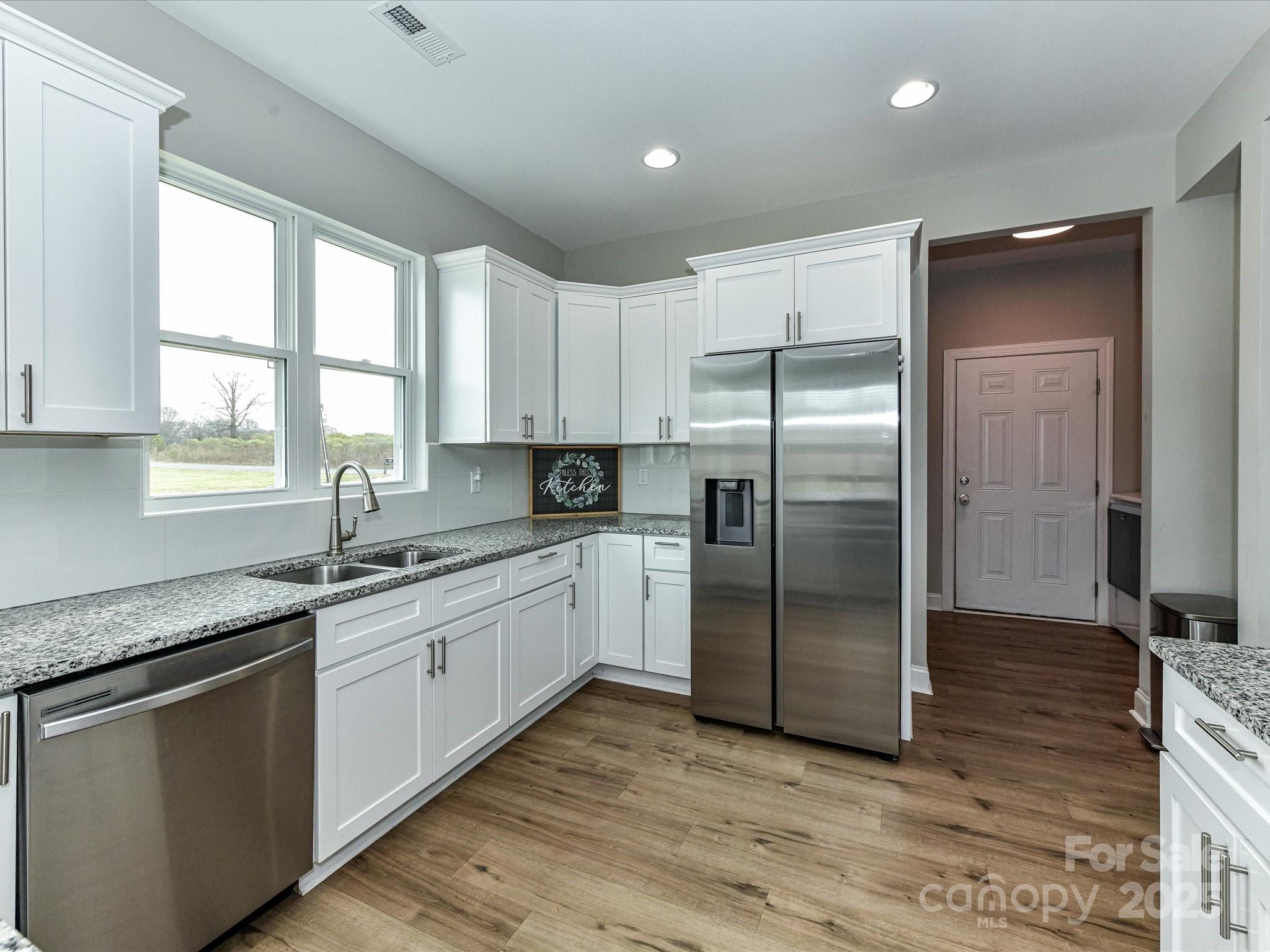 899 Hasty Road Marshville, NC 28103 - Photo 17 of 44 a kitchen with stainless steel appliances granite countertop a refrigerator sink and cabinets
