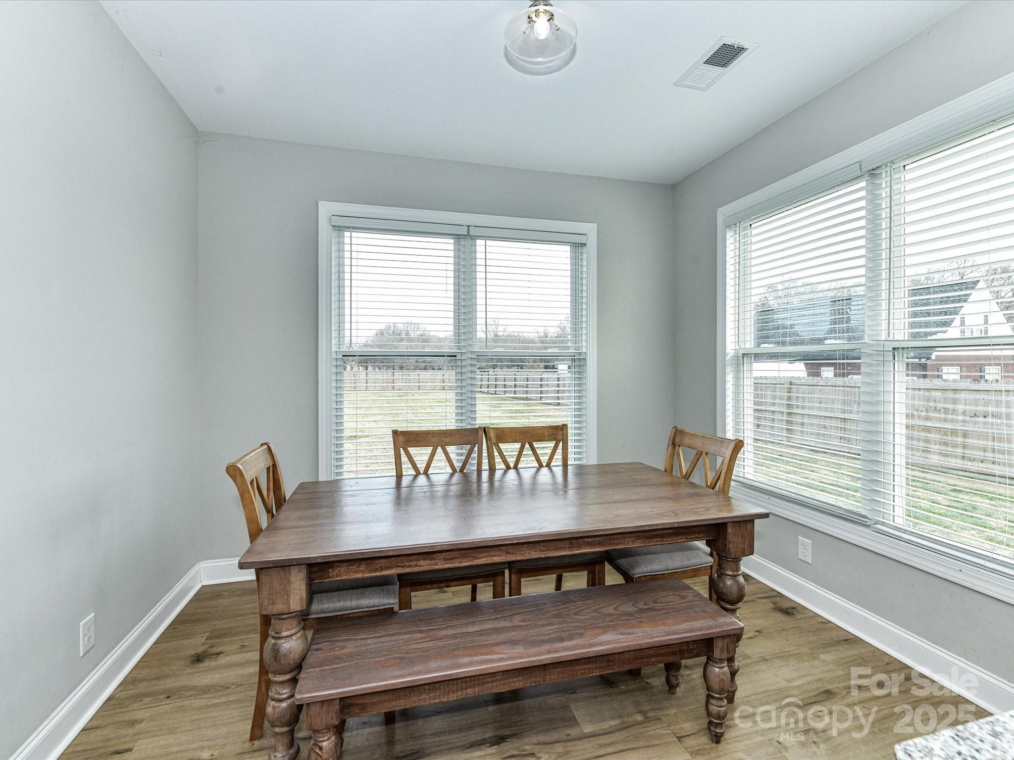 899 Hasty Road Marshville, NC 28103 - Photo 18 of 44 a view of a dining room with furniture window and wooden floor