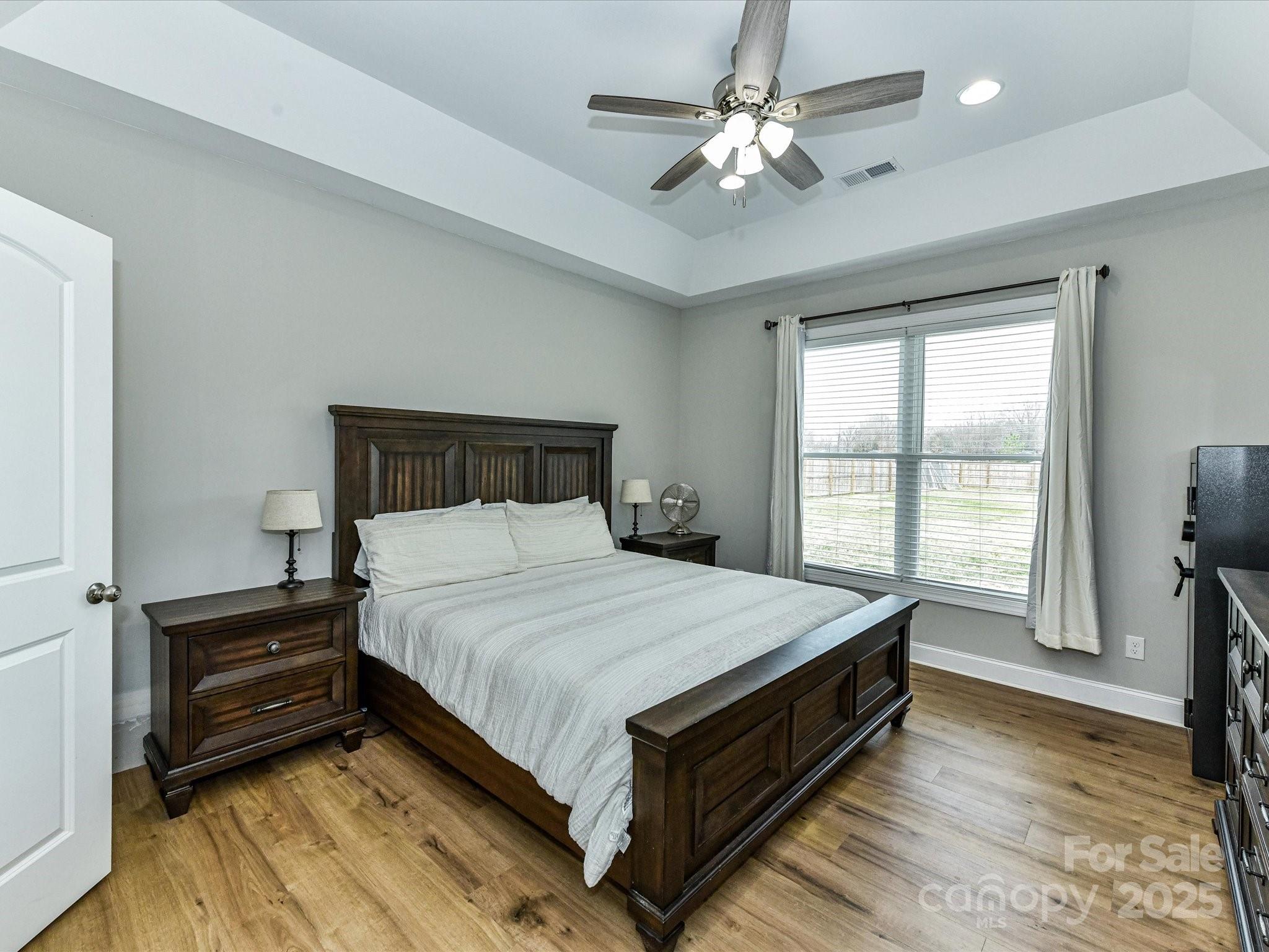 899 Hasty Road Marshville, NC 28103 - Photo 20 of 44 a bedroom with a bed chandelier and a window