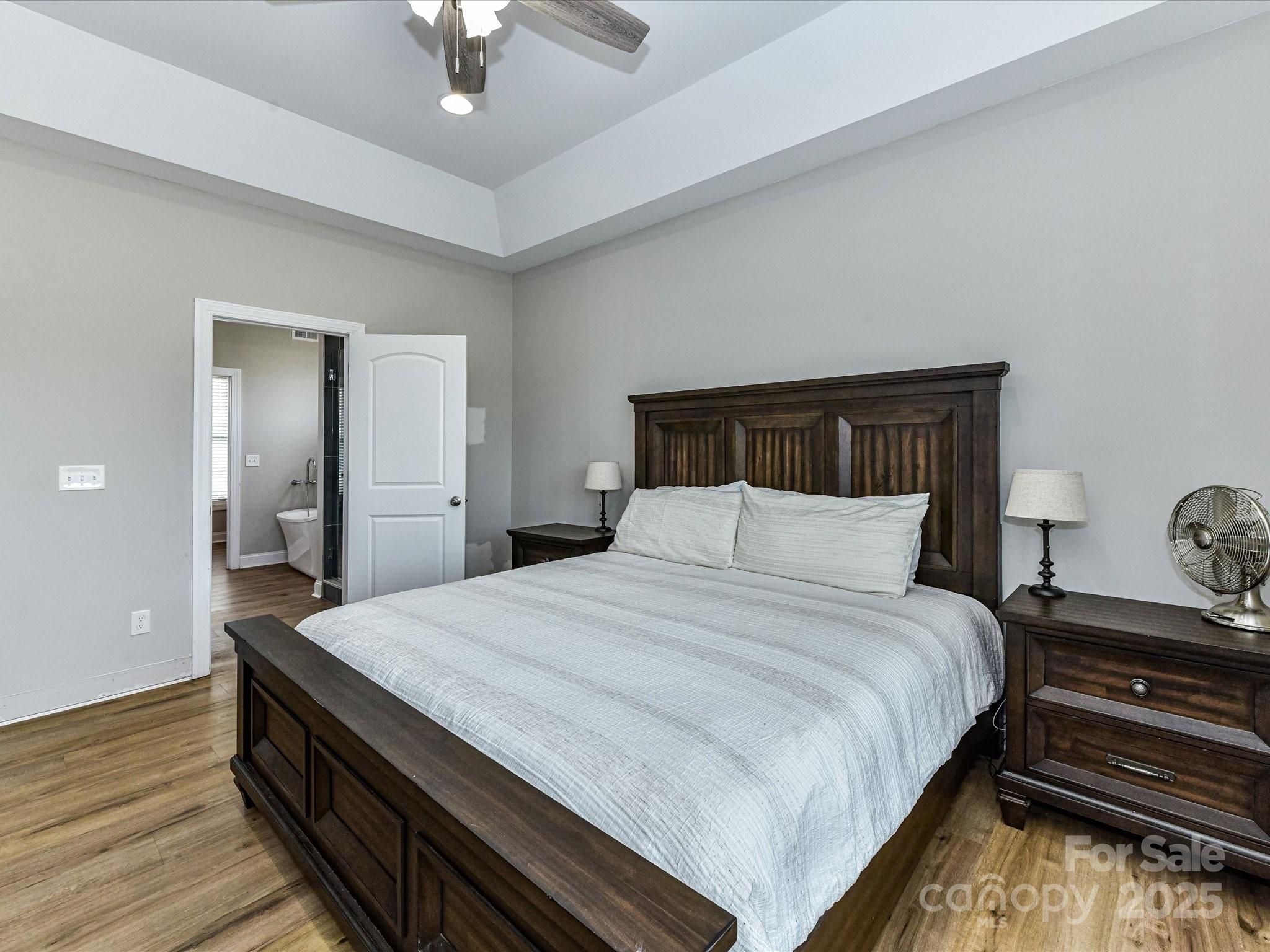 899 Hasty Road Marshville, NC 28103 - Photo 21 of 44 a bedroom with bed and wooden floor