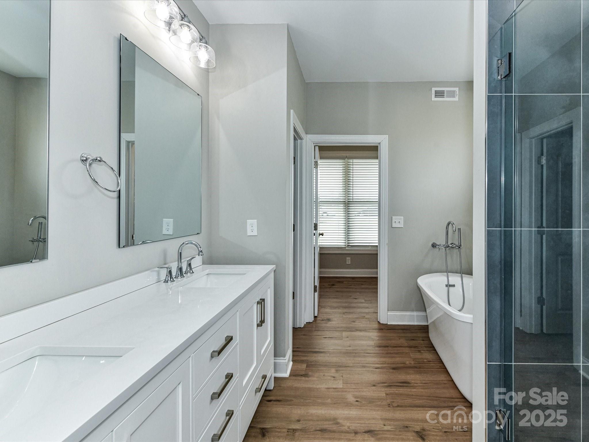 899 Hasty Road Marshville, NC 28103 - Photo 23 of 44 a bathroom with a double vanity sink and a mirror