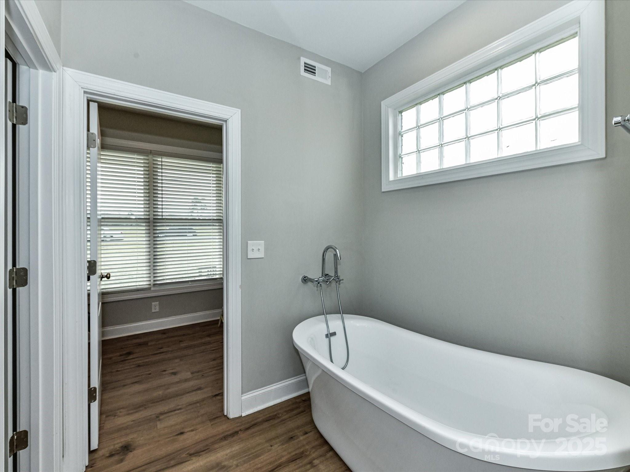 899 Hasty Road Marshville, NC 28103 - Photo 25 of 44 a bathroom with a bathtub and window