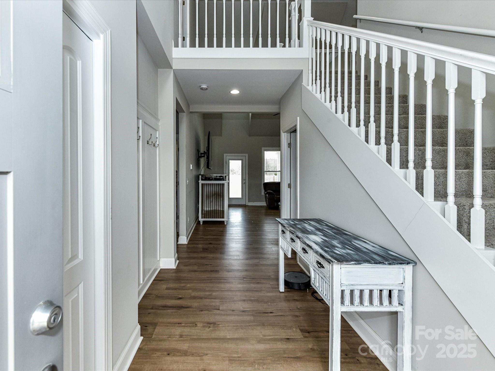 899 Hasty Road Marshville, NC 28103 - Photo 7 of 44 a view of a hallway with wooden floor and staircase