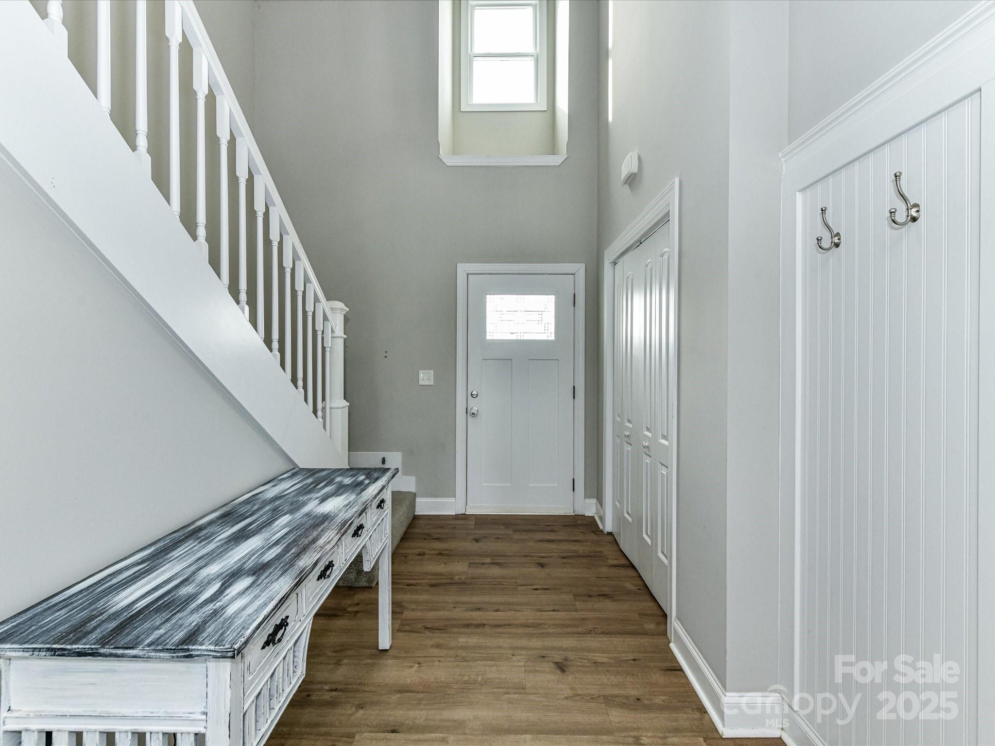 899 Hasty Road Marshville, NC 28103 - Photo 9 of 44 a view of a hallway with wooden floor and staircase