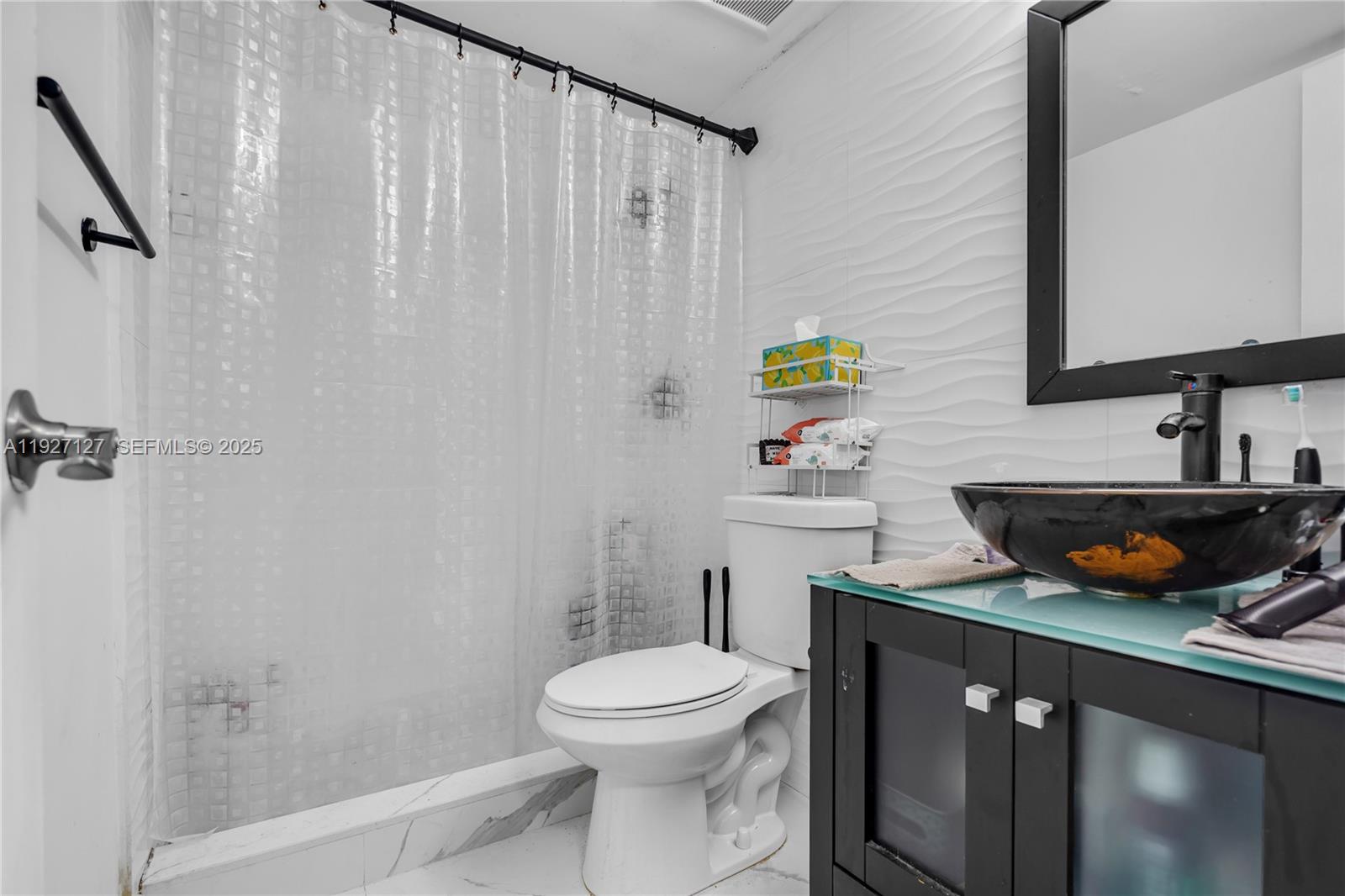 3601 Southwest 2nd Street, Unit 3601 Miami, FL 33135 - Photo 12 of 21 a bathroom with a sink a toilet and shower