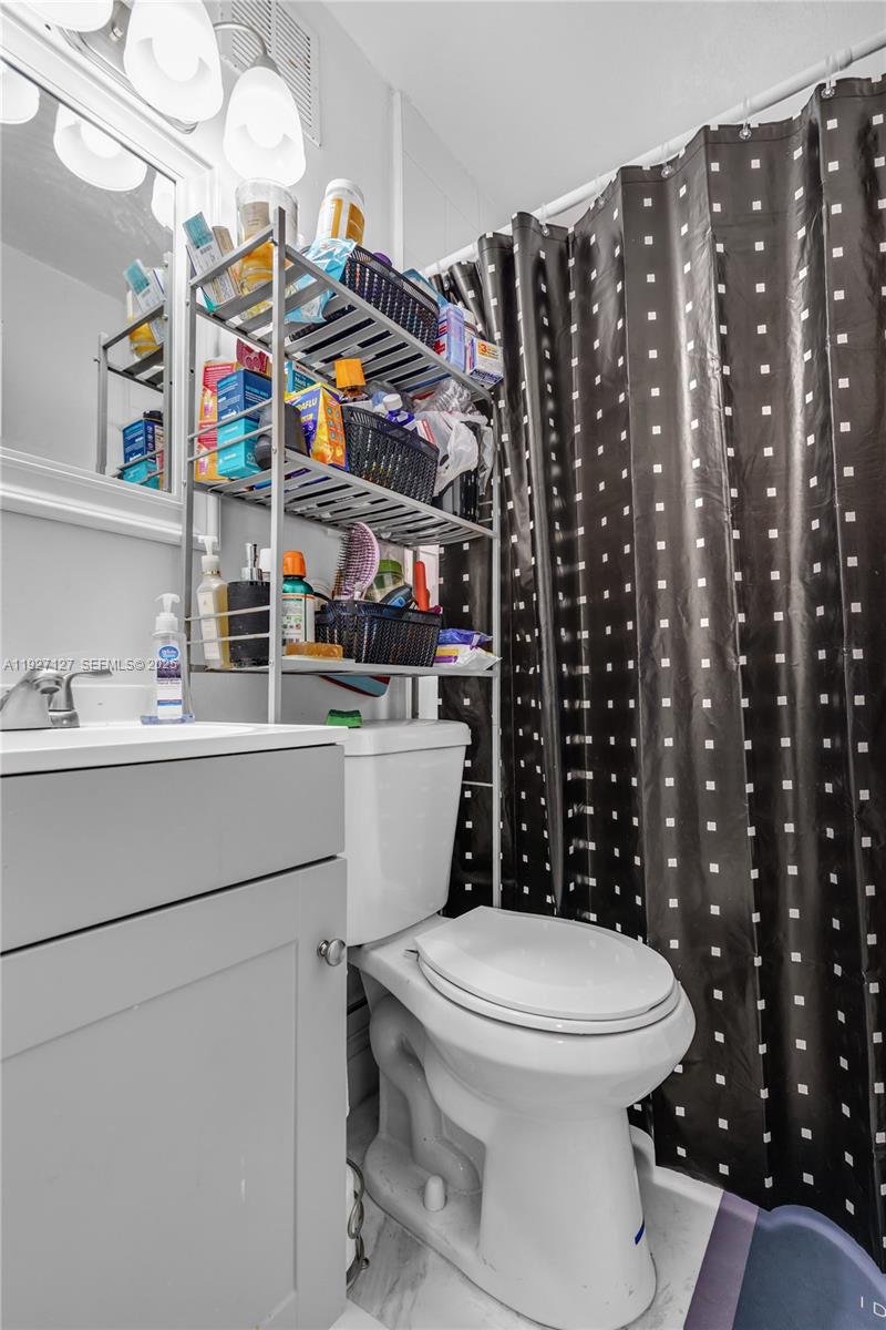 3601 Southwest 2nd Street, Unit 3601 Miami, FL 33135 - Photo 14 of 21 a bathroom with a toilet and a sink