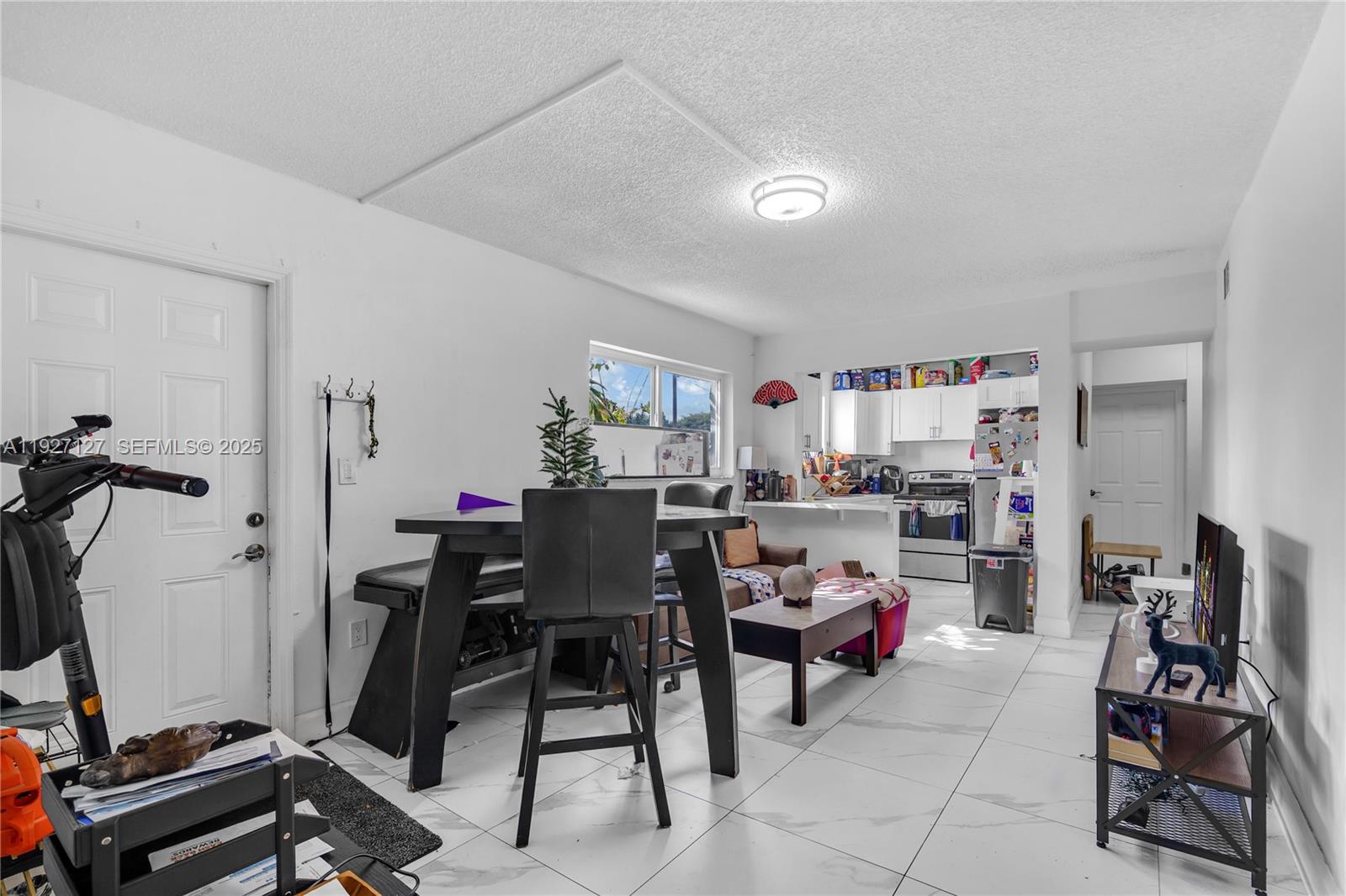 3601 Southwest 2nd Street, Unit 3601 Miami, FL 33135 - Photo 4 of 21 a view of a workspace with furniture and a window