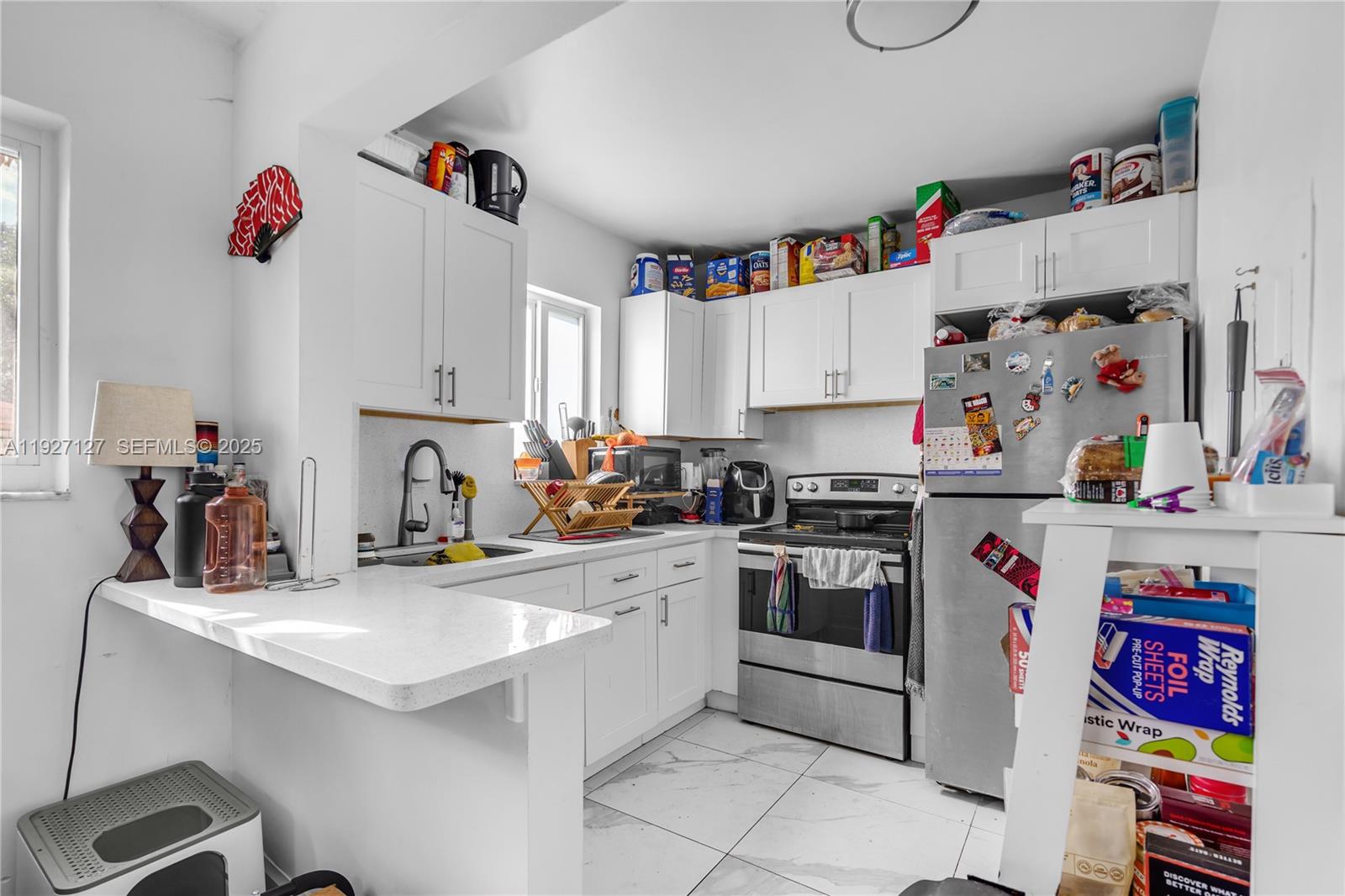 3601 Southwest 2nd Street, Unit 3601 Miami, FL 33135 - Photo 6 of 21 a kitchen with a sink and a stove top oven