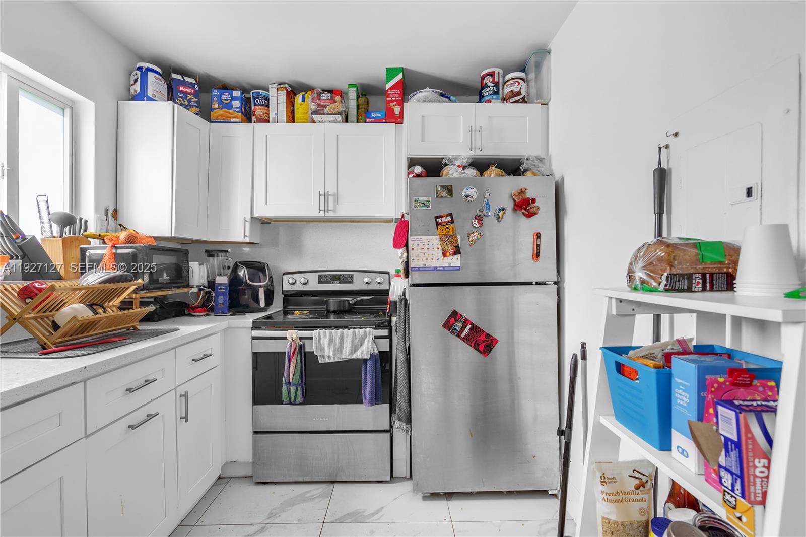3601 Southwest 2nd Street, Unit 3601 Miami, FL 33135 - Photo 7 of 21 a storage room with cabinets appliances and a window