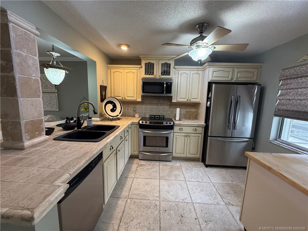 1950 Southwest Palm City Road, Unit 3306 Stuart, FL 34994 - Photo 12 of 49 a kitchen with a sink stove and refrigerator