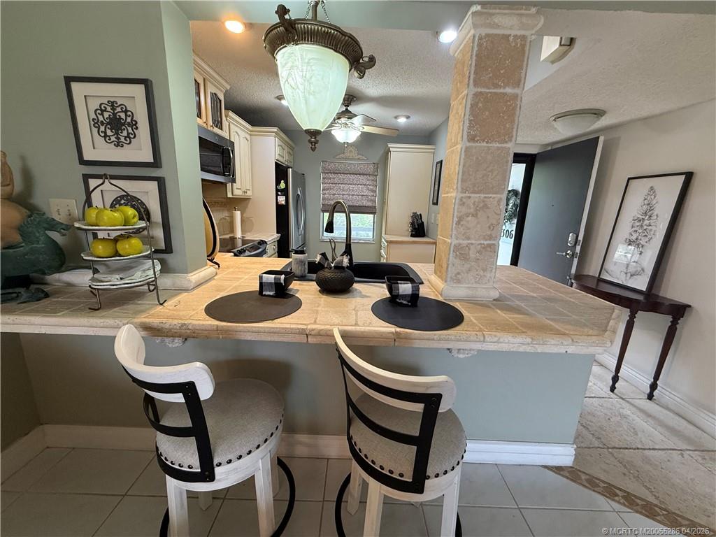 1950 Southwest Palm City Road, Unit 3306 Stuart, FL 34994 - Photo 15 of 49 a room with furniture a chandelier and a mirror