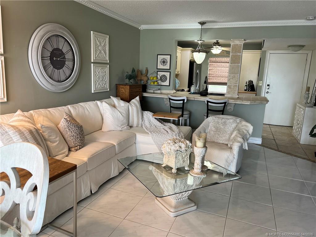 1950 Southwest Palm City Road, Unit 3306 Stuart, FL 34994 - Photo 17 of 49 a living room with furniture a clock and a view of bathroom