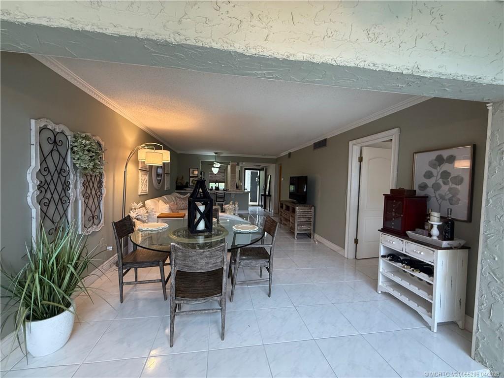 1950 Southwest Palm City Road, Unit 3306 Stuart, FL 34994 - Photo 22 of 49 a dining room with furniture and wooden floor