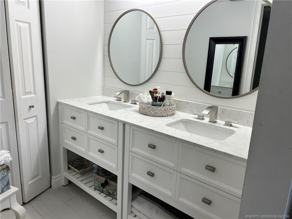 1950 Southwest Palm City Road, Unit 3306 Stuart, FL 34994 - Photo 27 of 49 a bathroom with a double vanity sink and a mirror