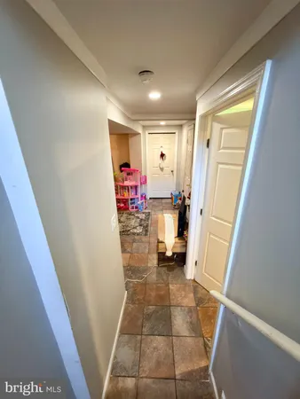 a view of a hallway and a livingroom with furniture