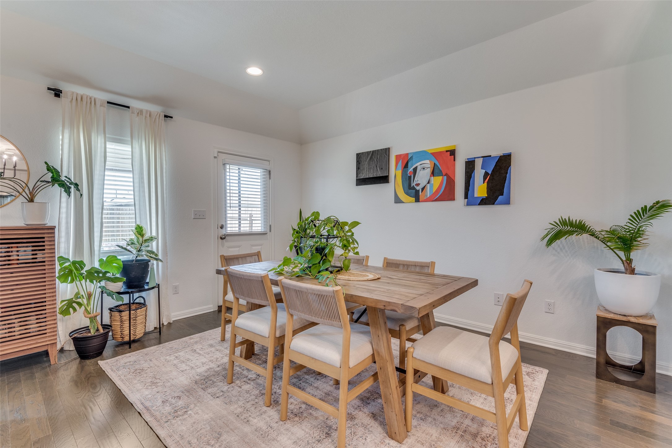 809 San Marcos Street Manor, TX 78653 - Photo 11 of 25 a view of a dining room with furniture window and wooden floor