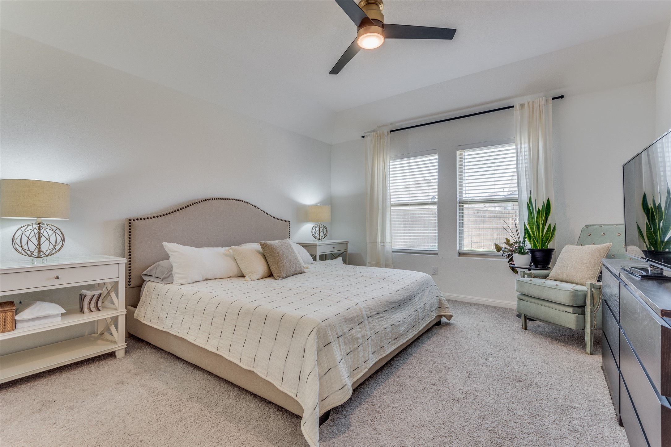 809 San Marcos Street Manor, TX 78653 - Photo 15 of 25 a bedroom with a large bed and windows