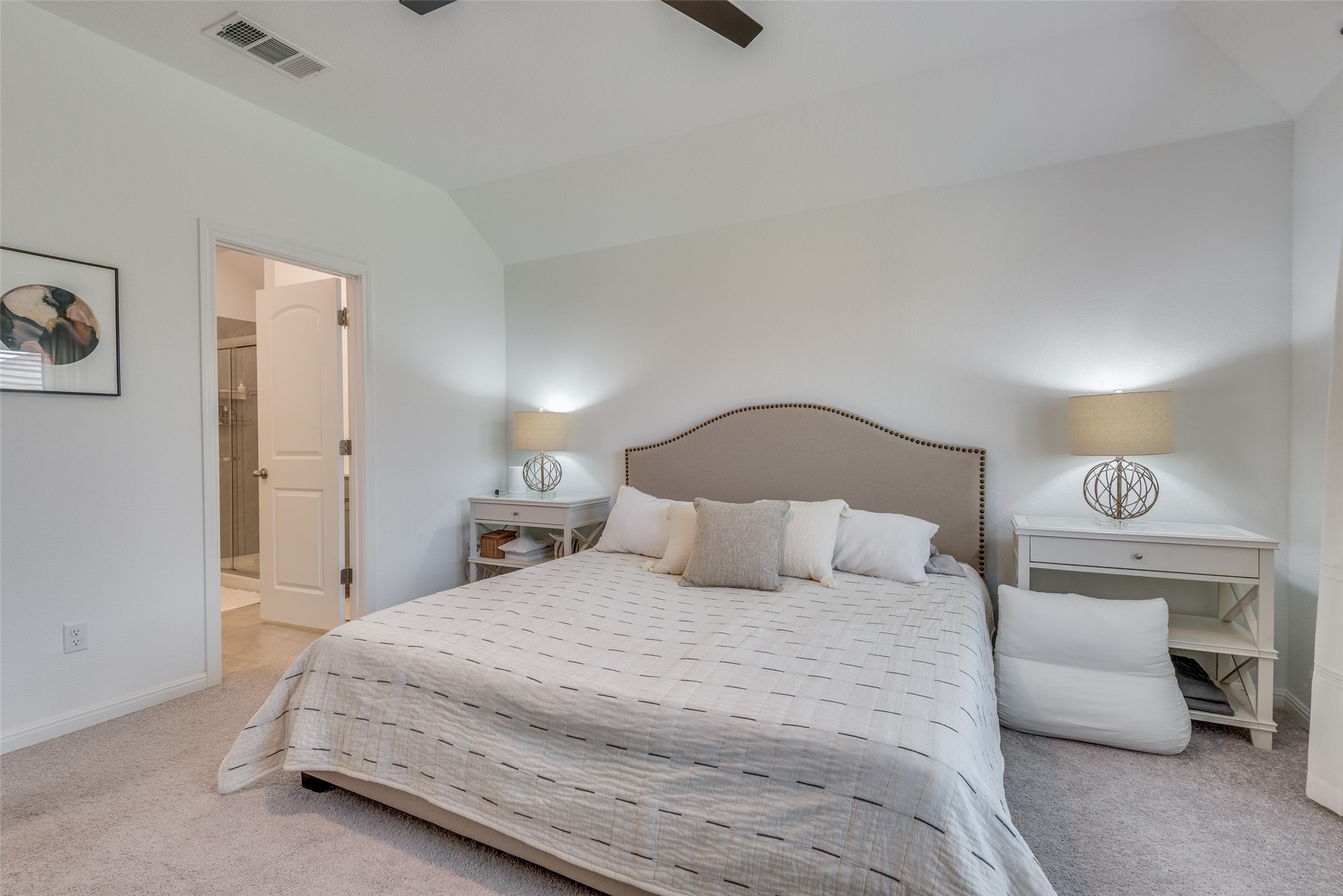 809 San Marcos Street Manor, TX 78653 - Photo 16 of 25 a bedroom with a bed and a lamp