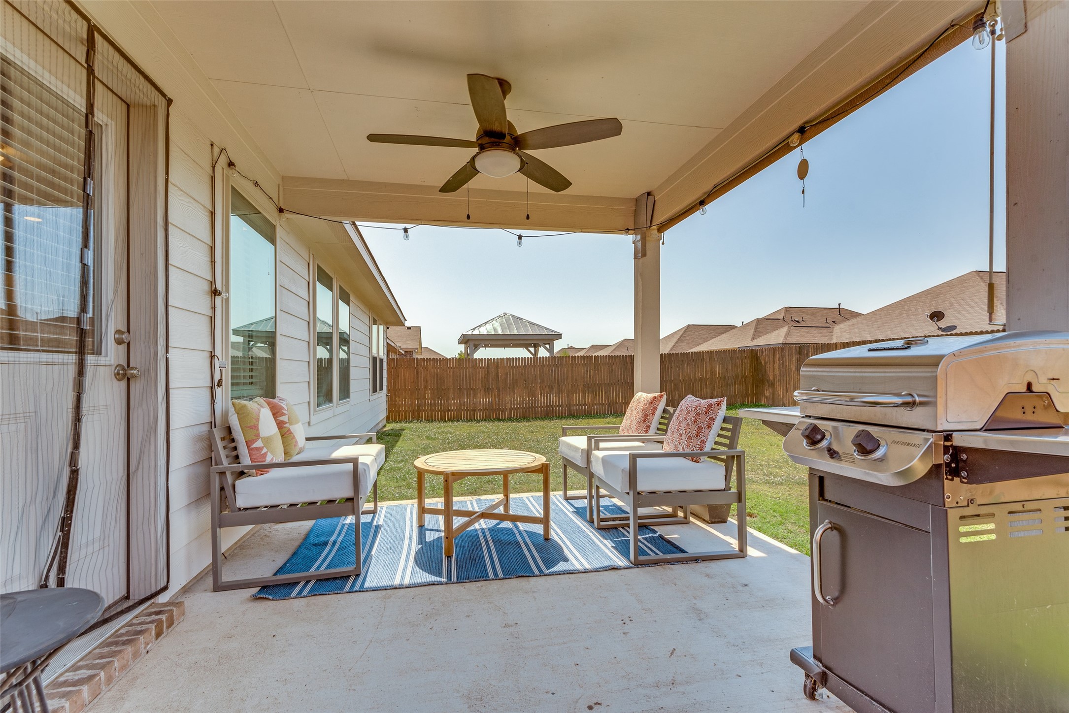 809 San Marcos Street Manor, TX 78653 - Photo 21 of 25 a view of a patio with a table and chairs