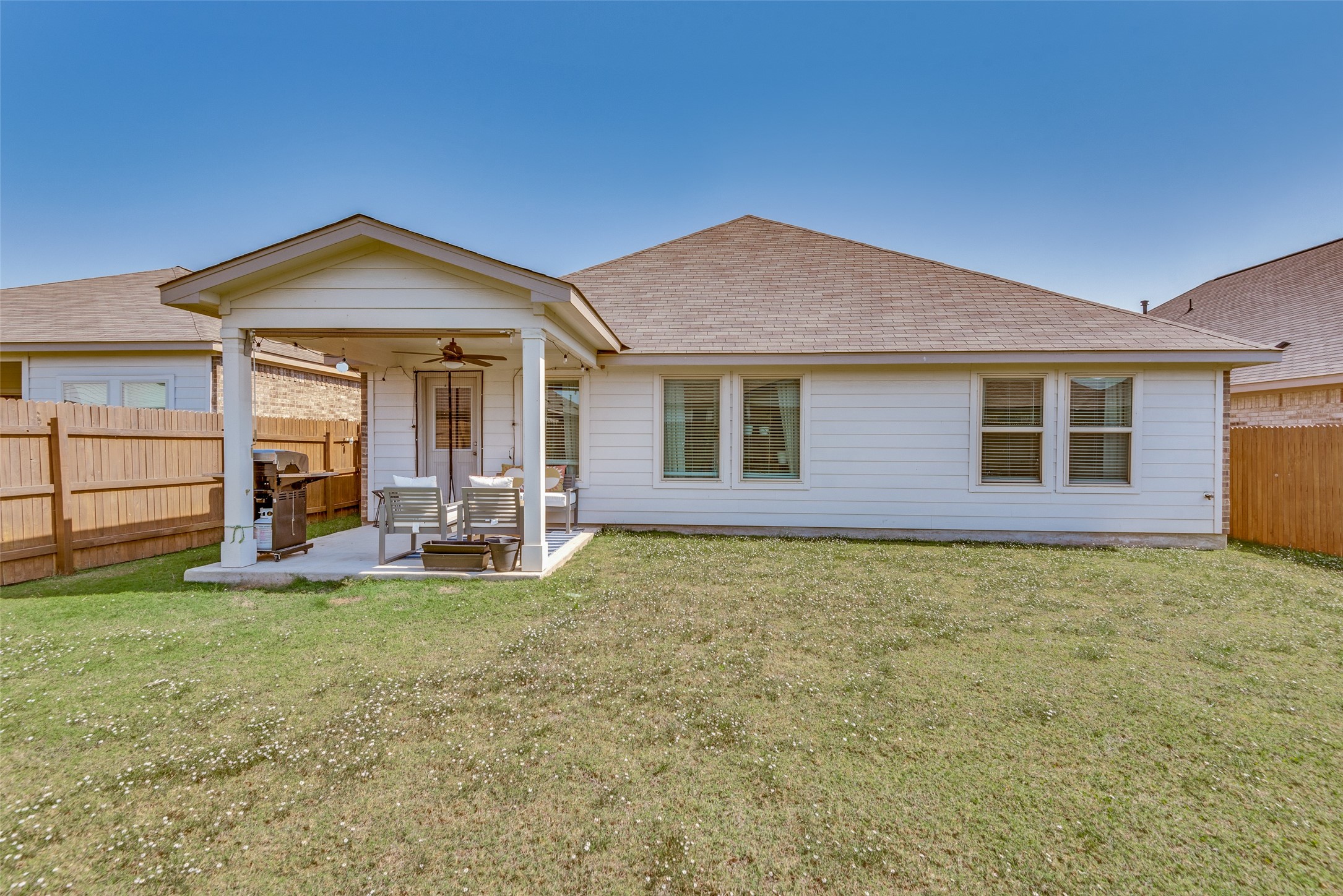 809 San Marcos Street Manor, TX 78653 - Photo 22 of 25 a view of a house with backyard porch and a cabin