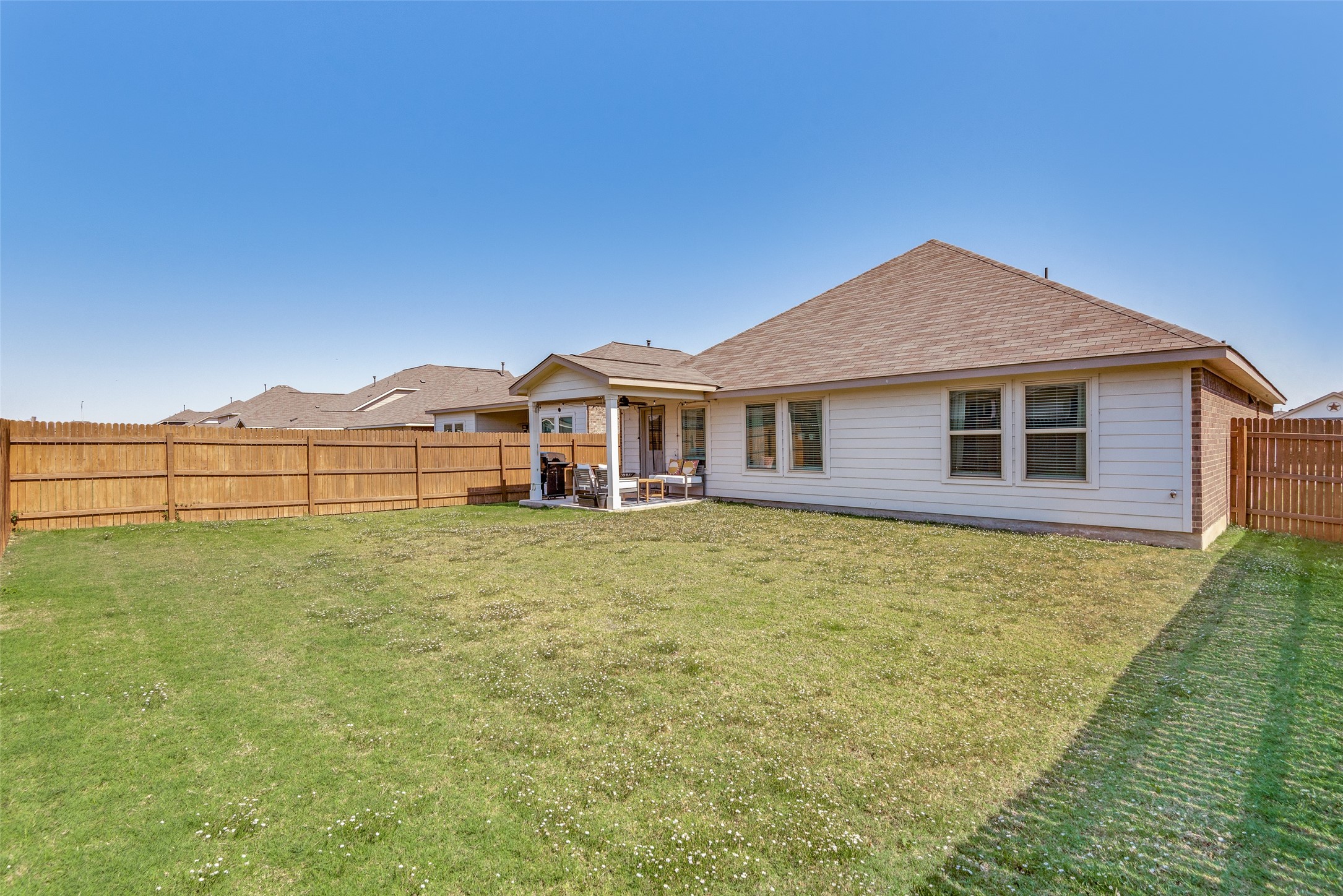 809 San Marcos Street Manor, TX 78653 - Photo 23 of 25 a front view of a house with a garden