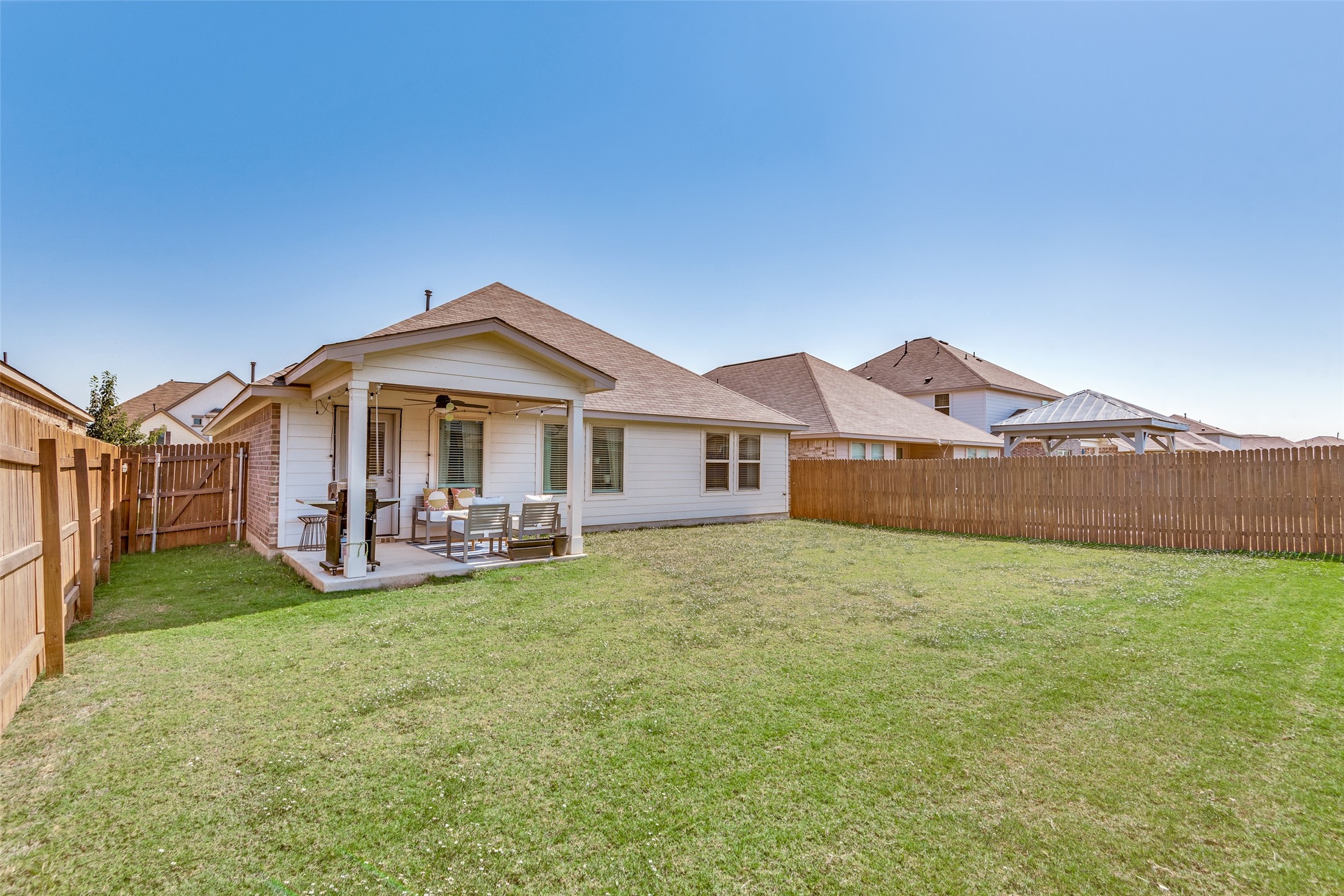 809 San Marcos Street Manor, TX 78653 - Photo 24 of 25 a view of a house with backyard and porch