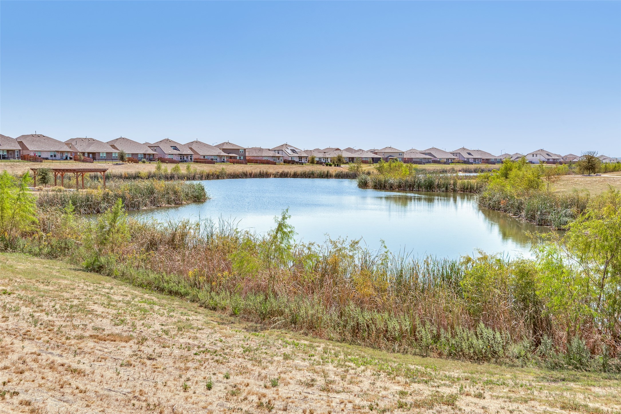 809 San Marcos Street Manor, TX 78653 - Photo 25 of 25 a view of a lake with a city