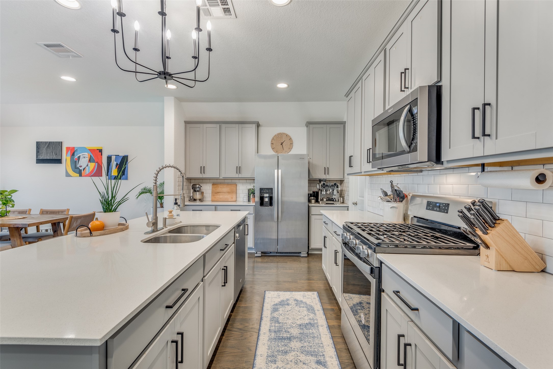 809 San Marcos Street Manor, TX 78653 - Photo 7 of 25 a kitchen with stainless steel appliances a sink stove and cabinets