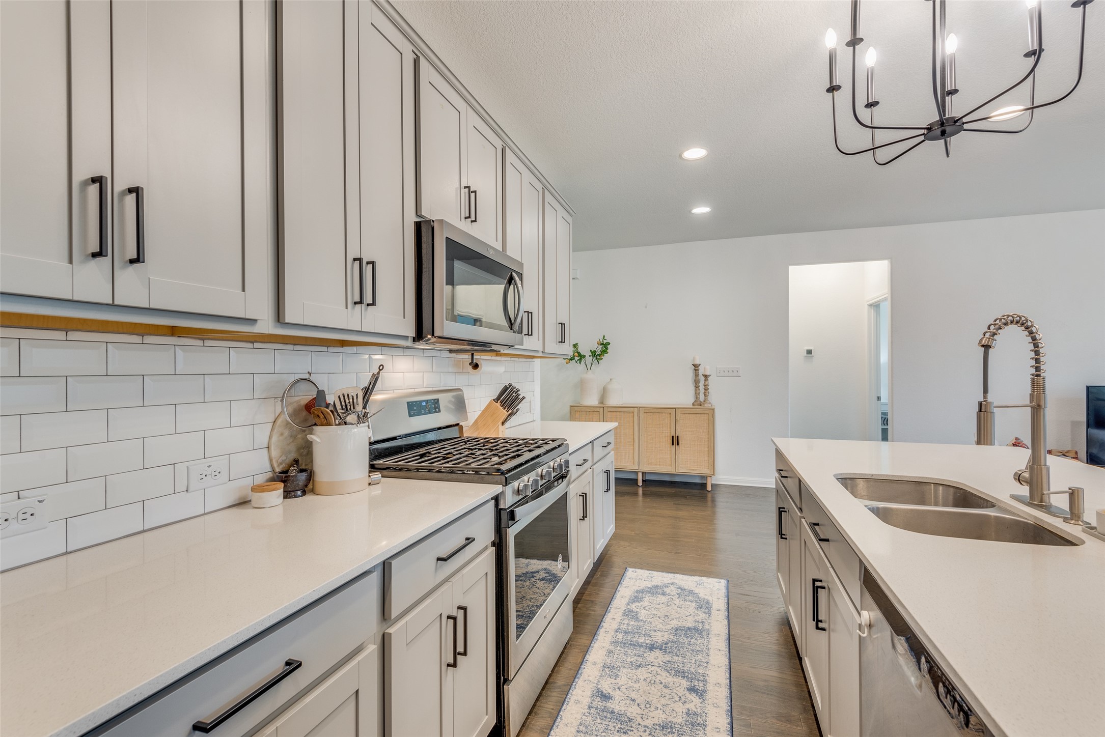 809 San Marcos Street Manor, TX 78653 - Photo 8 of 25 a kitchen with a sink stove and cabinets