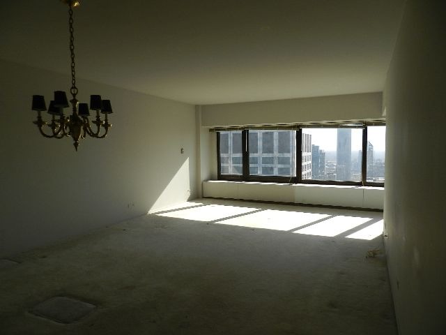 175 East Delaware Place, Unit 7109 Chicago, IL 60611 - Photo 2 of 14 a view of an empty room with a window