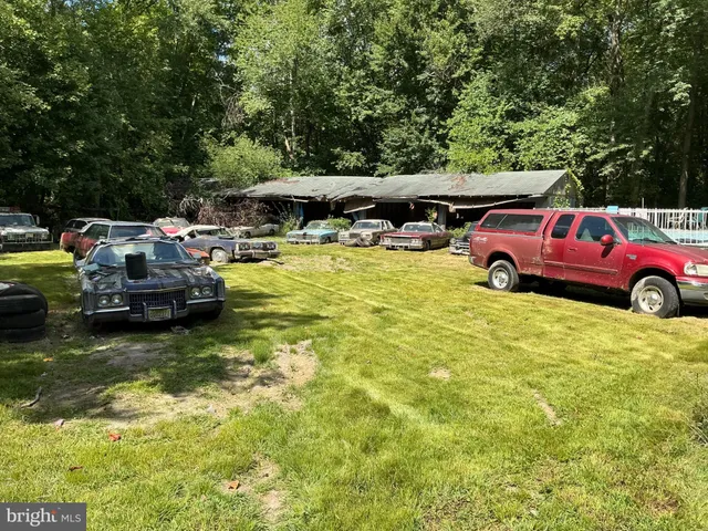 a view of a house with swimming pool and furniture
