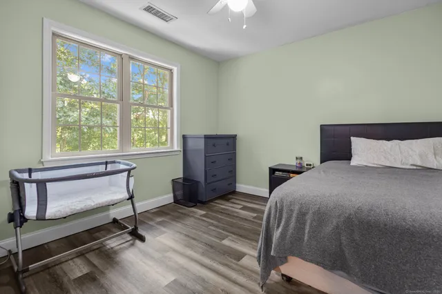 a bedroom with a bed and a window