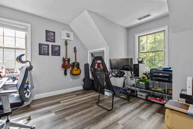 a view of a workspace with furniture and a window