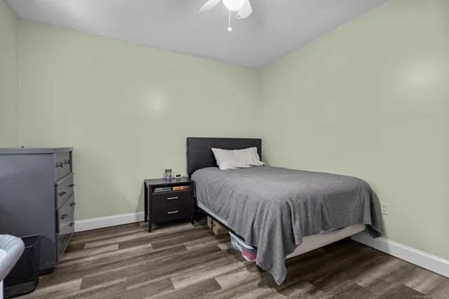 a bed sitting in a bedroom next to a lamp