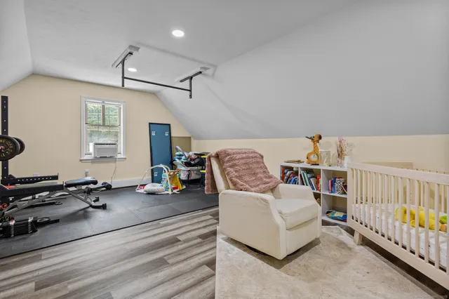 a bedroom with furniture and a window