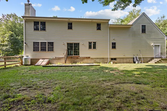 a backyard of a house with table and chairs