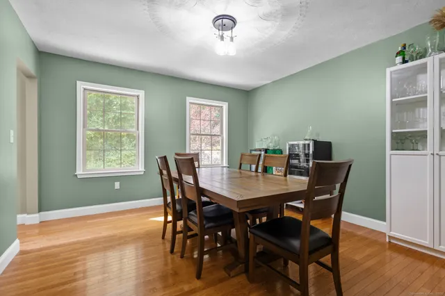 a view of a dining room with furniture window and wooden floor