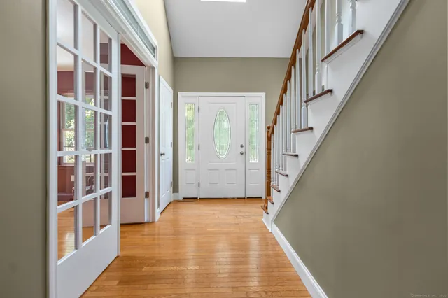 a view of a hallway with a white walls and stairs