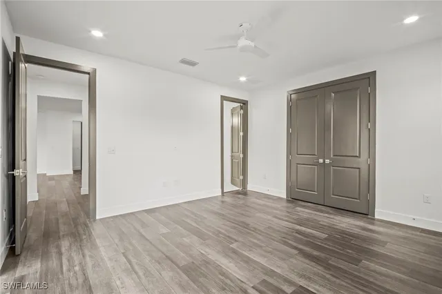 a view of empty room with wooden floor