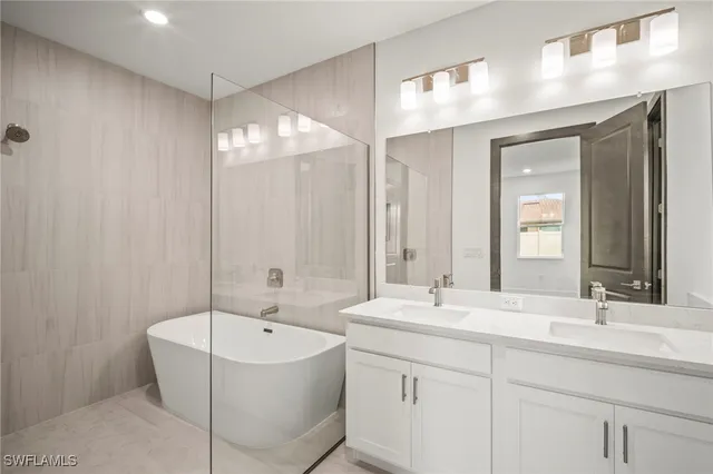 a bathroom with a bathtub a sink and a mirror