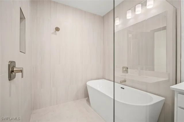 a bathroom with a bathtub and shower