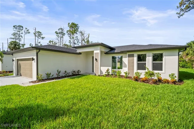 a front view of house with yard and outdoor seating