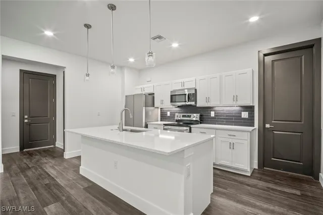 a kitchen with stainless steel appliances a refrigerator stove microwave and cabinets