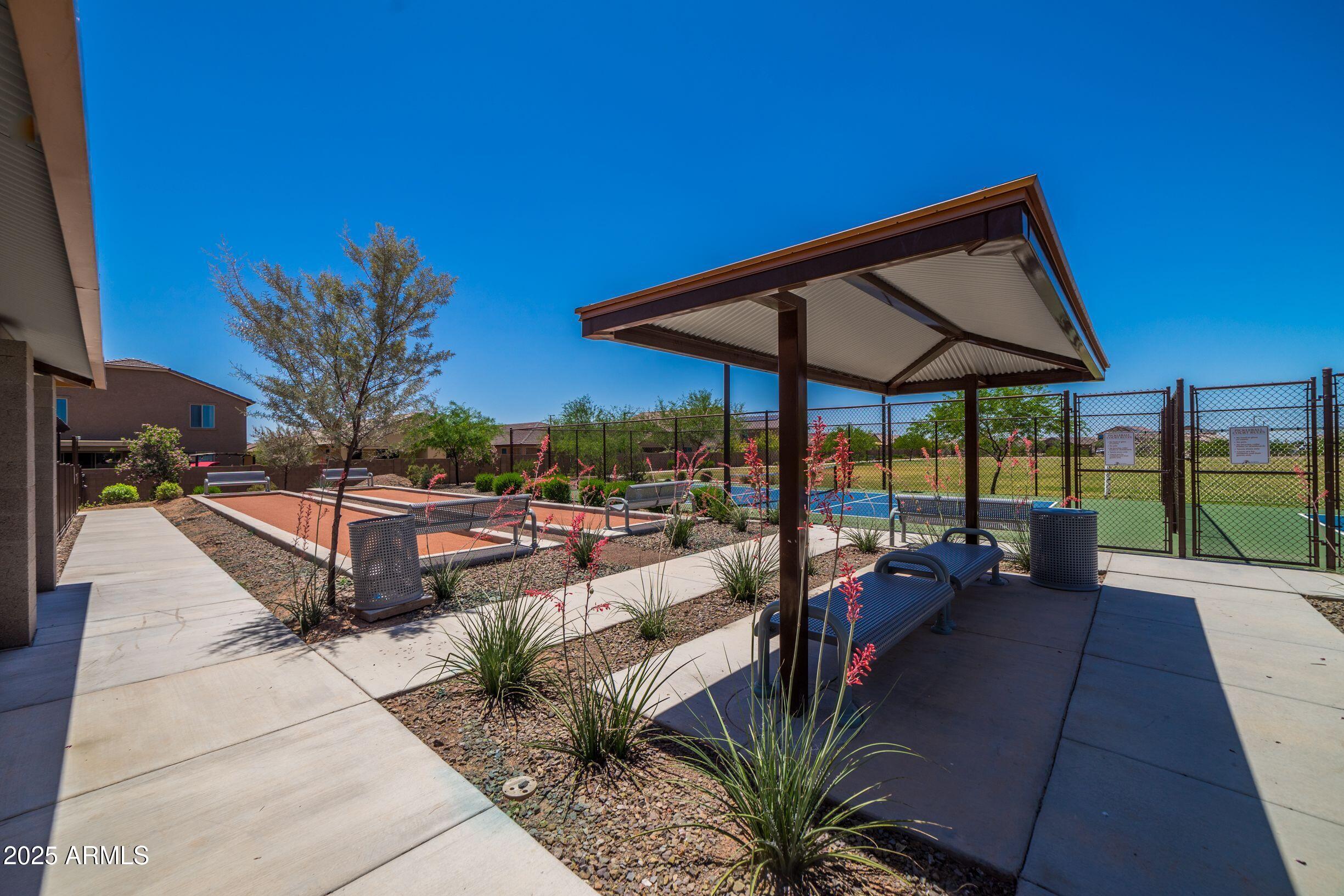 17255 West Patrick Lane Surprise, AZ 85387 - Photo 6 of 8 a view of a patio with a table and chairs under an umbrella