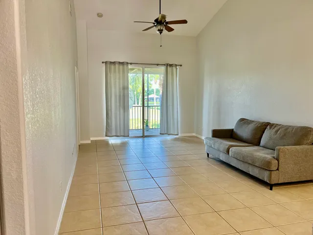 a living room with a couch and a chandelier